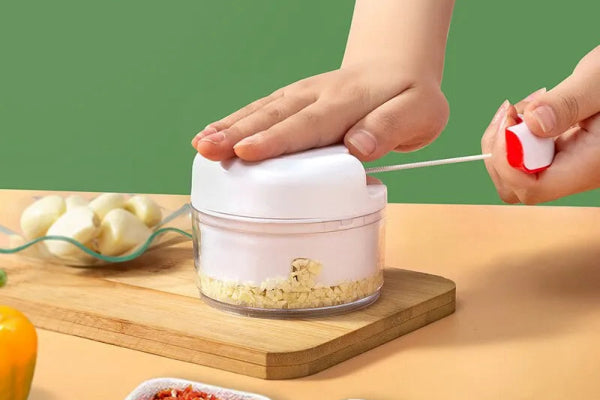 White hand pulled garlic grinder for easy chopping; features a palm design, multifunctional food processor, perfect for garlic and herbs.