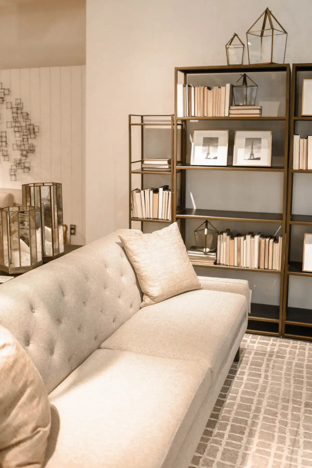 Cream-colored tufted sofa with throw pillows.