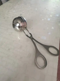 Metal ice cream scoop with scissor-style handles.