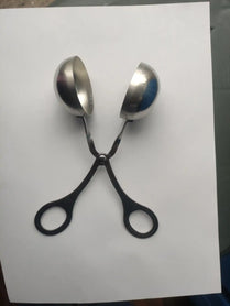 Metal spoons arranged to look like scissors.