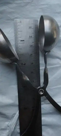 Pair of scissors next to a metal ruler.