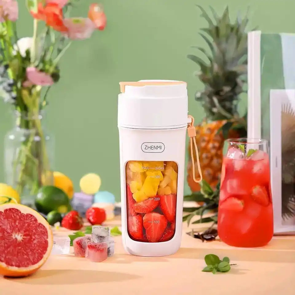 Portable white blender with fruit.