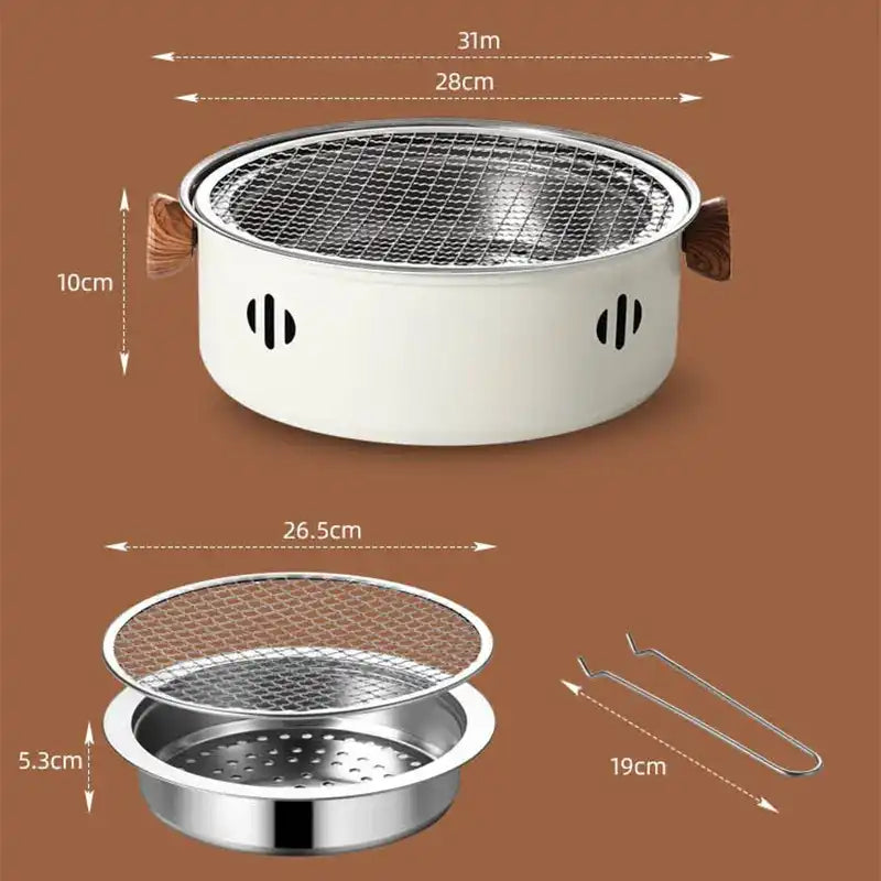 White round tabletop charcoal grill with metal grates and tongs.